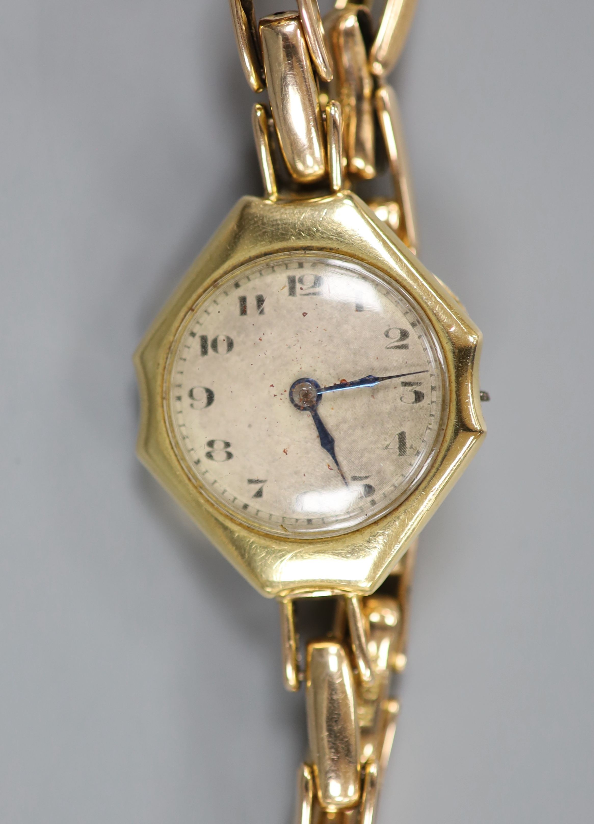 A lady's 18ct gold manual wind wrist watch(a.f.), on a 15ct expanding bracelet